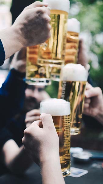 Beer glasses being raised in a toast