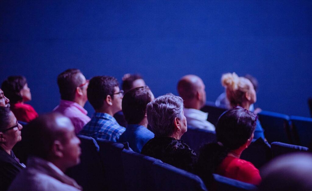 Audience watching a movie in a theater