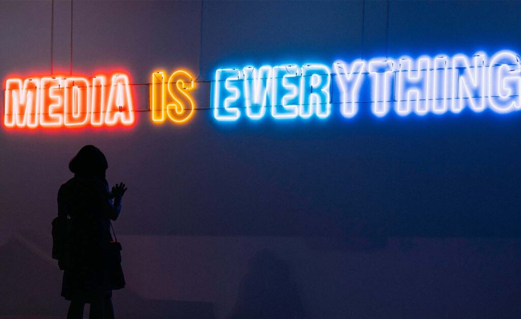 "Media is everything" in neon lettering