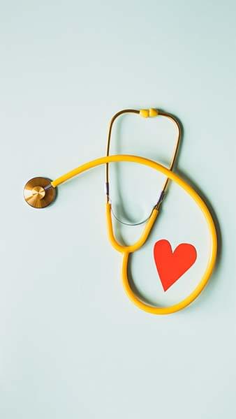 Stethoscope wrapped around a paper heart