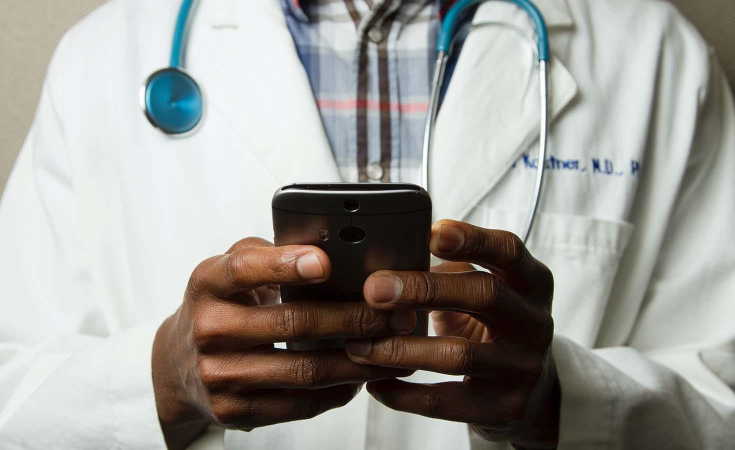 Close up of doctor using a smart phone.