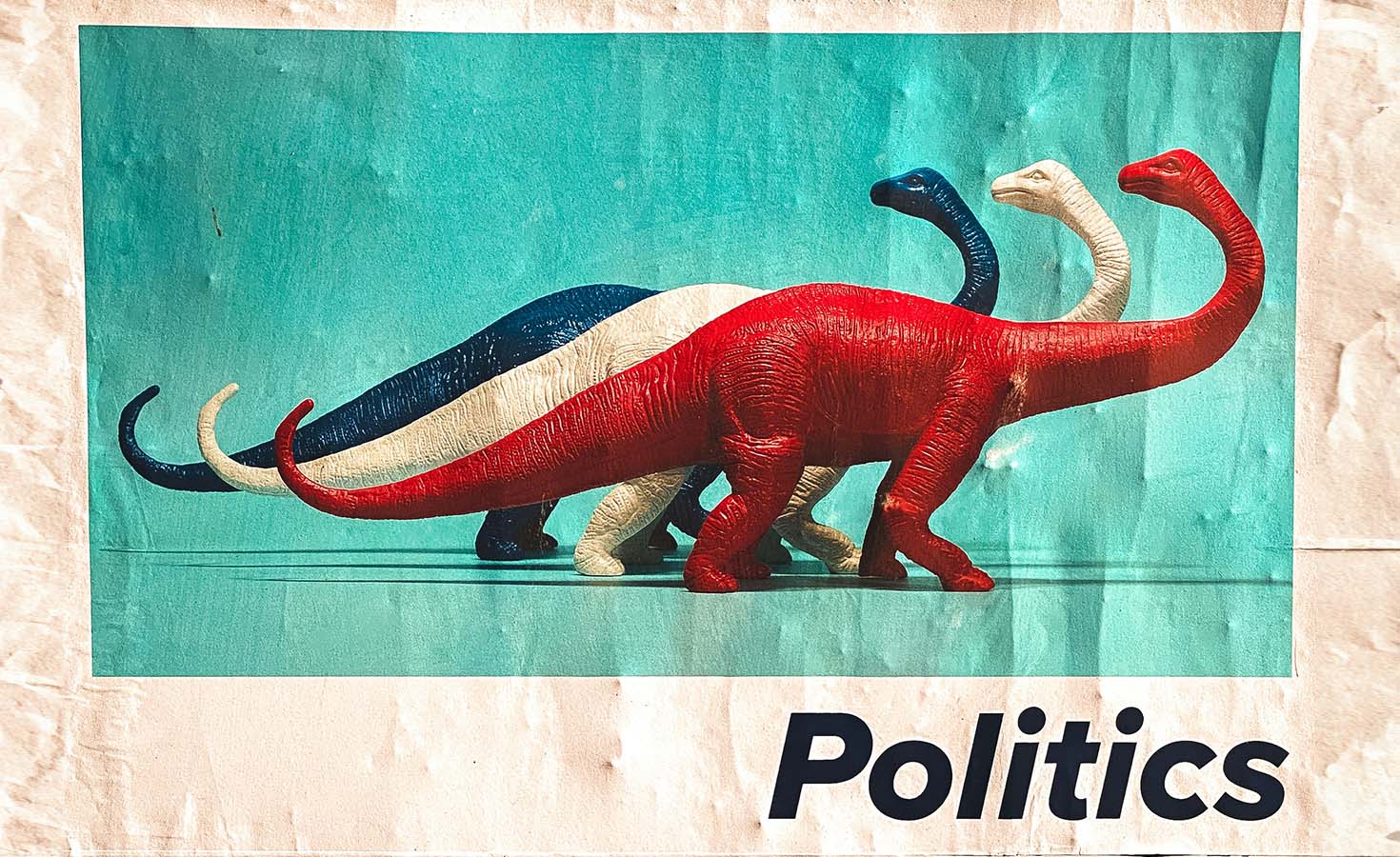 Red, white, and blue toy dinosaurs with the word 'politics' in the corner of the image.