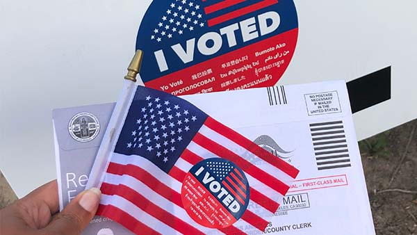 Voting materials with a United States flag and 'I Voted' sticker.