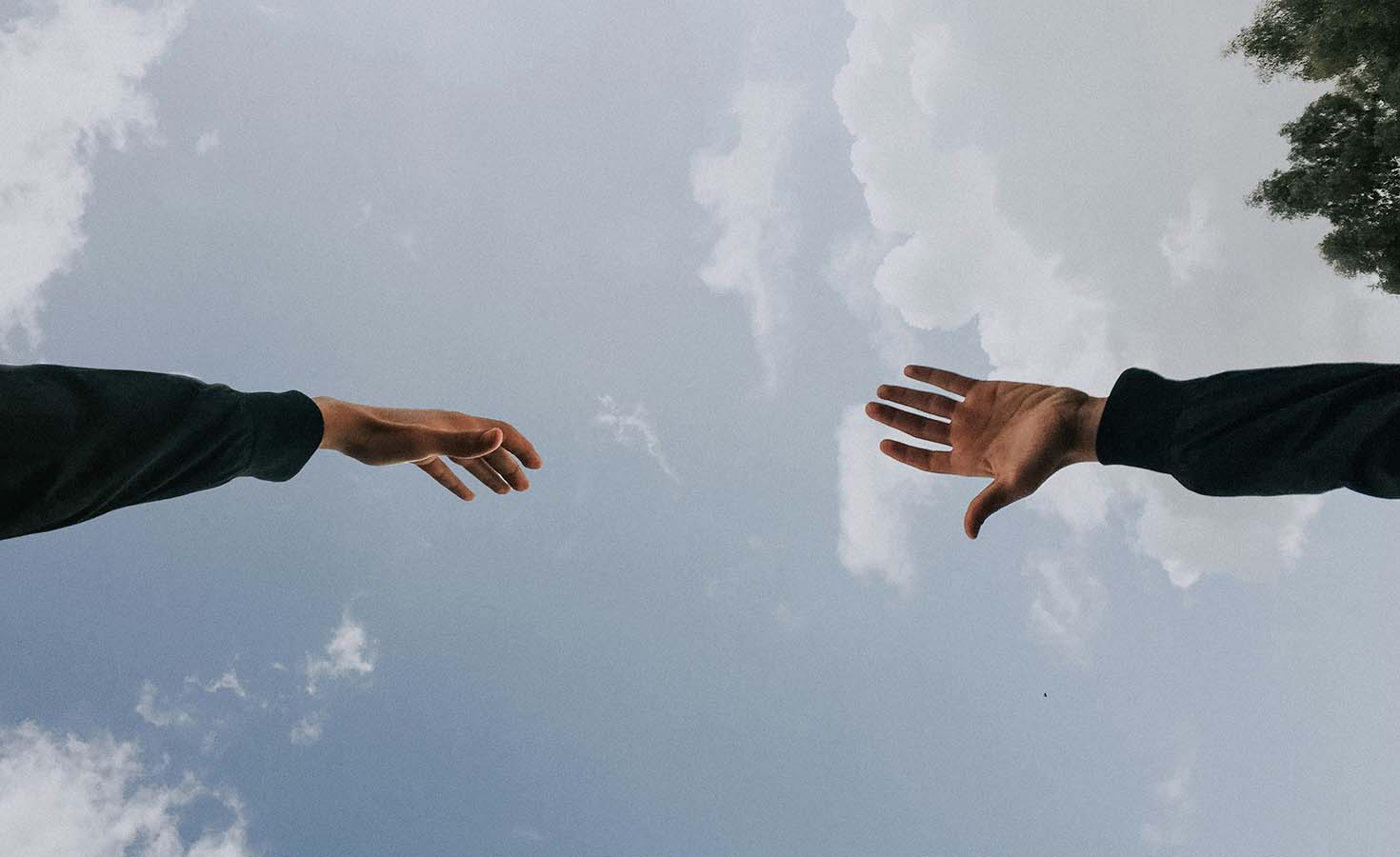 Two hands reaching towards each other